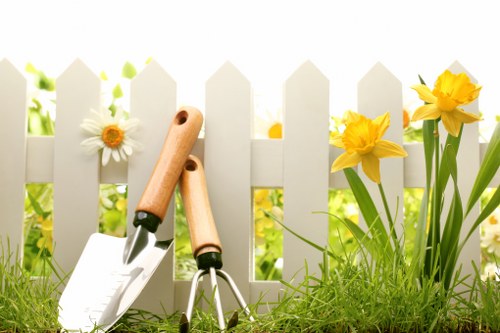 Gardener using hedge trimming tools